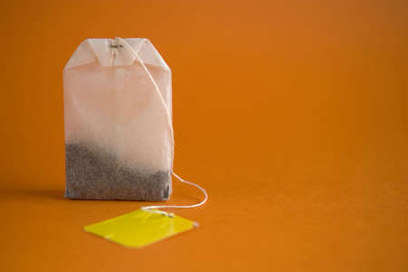Tea bag with a yellow labelの写真素材