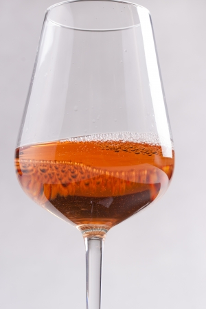 Rose wine glass on a solid bright backgroundの写真素材