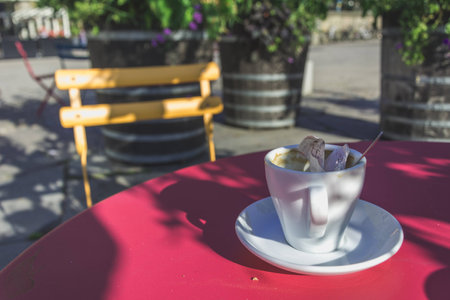 One Coffee Cup with a Spoon and a Rumpled Receiptの写真素材