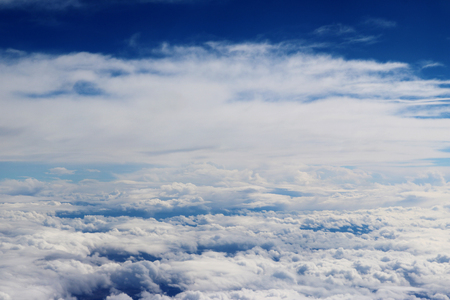 Clouds seen from an airplane, blue sunshine, soil background nature landscapeの写真素材