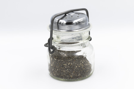 Poppy seeds in a glass storage container with metal lidの写真素材