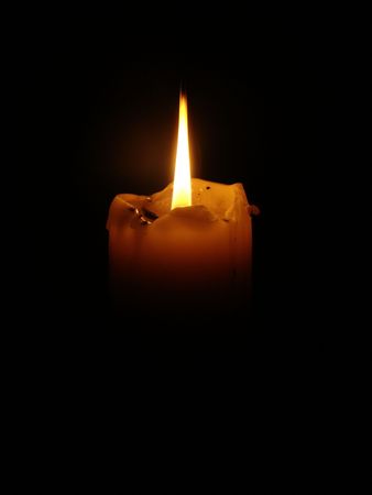 photo shows a lighted candles on a black background.の写真素材