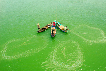This is artwork. The author captures fishermen fishing on the coast of Viet nam.のeditorial素材