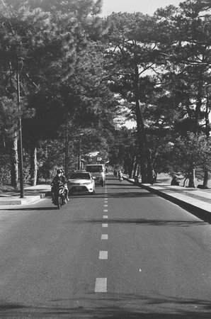 Black and white landscape photo film: street life in DaLat city. Time: March 5, 2022. Location: DaLat city.  Da Lat is a famous tourist city in Vietnamのeditorial素材