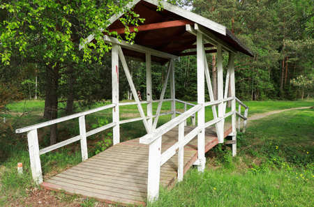 Small wooden footbridge with roofの写真素材