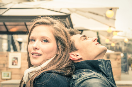 Couple of lovers at the beginning of a love story - Concept of happiness with ectstatic feelings in a very special moment of young people lifestyle - Warm desaturated nostalgic filtered lookの写真素材