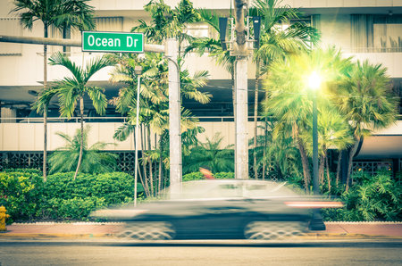 Modern car speeding along Ocean Drive in Miami South Beach before Sunsetのeditorial素材