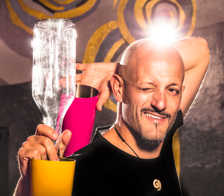Freestyle American Bartender - Two colored Shakers and Bottleの写真素材