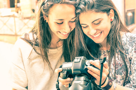 Young girls watching photos in a digital Cameraの写真素材