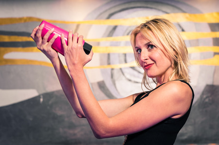 Barmaid shaking Cocktailの写真素材