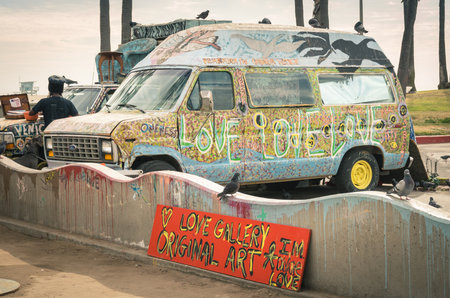 VENICE, UNITED STATES - DECEMBER 18, 2013: hippie artistic minivan on the Ocean Front Walk in Venice Beach. The image has been edited with slightly vintage retro nostalgic filtered look and vignettingのeditorial素材