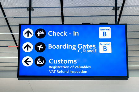 Info sign at international airport - Directions for check in and boarding gates - Registrations and custom at terminal connectionsの写真素材