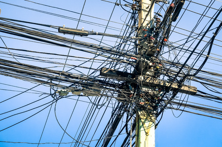Messy electrical cables in thailand - Uncovered optical fiber technology open air outdoors in asian citiesの写真素材