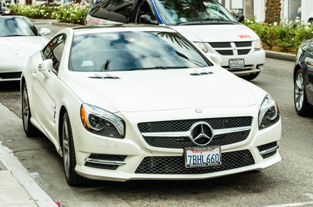 LOS ANGELES - DECEMBER 18, 2013: white Mercedes Benz SL 550 parked on Rodeo Drive. The brand is used...
