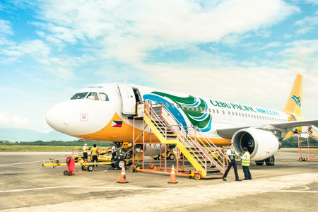 PUERTO PRINCESA, PHILIPPINES - 15 FEBRUARY, 2015: staff people moving around Cebu Pacific aircraft...