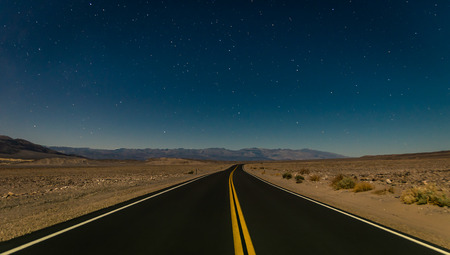 Desert road in the Death Valley by nightの写真素材