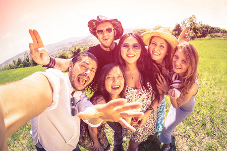 Best friends taking selfie at countryside picnic - Happy friendship concept and fun with young people and new technology trends - Vintage filter look with marsala color tones - Fisheye lens distorsion