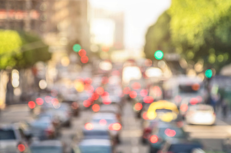 Rush hour with defocused cars and generic vehicles - Traffic jam in Los Angeles downtown - Blurred bokeh postcard of american iconic city with bright daylight colors - Real life transportation concept Rush hour with defocused cars and generic vehicles - Traffic jam in Los Angeles downtown - Blurred bokeh postcard of american iconic city with bright daylight colors - Real life transportation concept