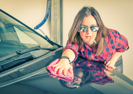 Young beautiful woman cleaning her Car at Carwashの写真素材