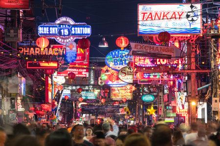 PATTAYA, THAILAND - FEBRUARY 18, 2016: multicolored neon signs and blurred people on the new Walking Street of the city - The road is closed to the traffic after 6pm and stays crowded until late nightのeditorial素材