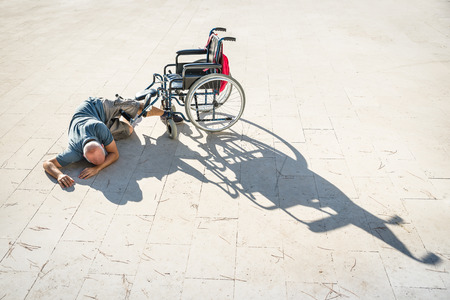 Disabled man with handicap having an accident crash with wheelchair