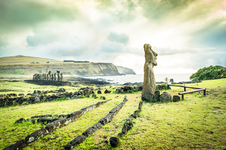Moai Ha'ere Ki Haho " The Traveling Statue " at the entrance of Ahu Tongariki spot area on world famous Easter Island in Chile - Travel wanderlust concept - Vivid green filter on dramatic cloudy skyの写真素材