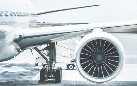 Detail of airplane engine wing at terminal gate before takeoff - Wanderlust travel concept around...