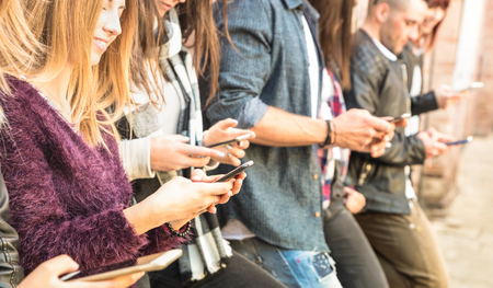 Group of multicultural friends using smartphone at university college backyard break - People hands...