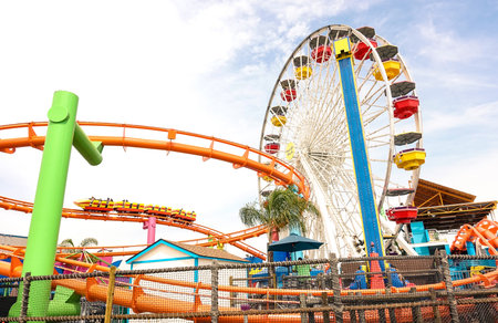 LOS ANGELES - 18 MARCH 2015: side horizontal view of multicolored ferris wheel at Santa Monica Pier at Pacific Amusement Park - Landmark on the californian coast at the foot of Colorado Avenueのeditorial素材