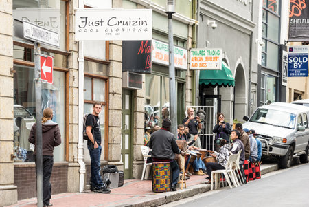 CAPE TOWN, SOUTH AFRICA - NOVEMBER 15, 2014: everyday life on Longmarket Street where multicolor melting pot of locals and turists meet on social hangouts - Multiethnic concept in south african cityのeditorial素材