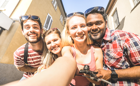 Multiracial friends taking selfie outdoors - Happy friendship concept with young students having fun together - Millenial people on peace and love concept against racism - Warm bright filterの写真素材