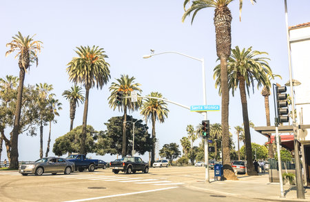 SANTA MONICA, USA - MARCH 20 2015: everyday traffic with cars on the street at crossroad corner between Broadway road and Ocean Ave on the coast near Los Angeles in California state - Warm filterのeditorial素材