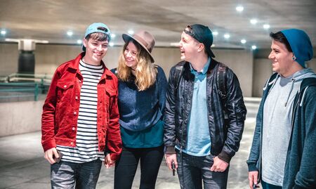 Best friends guys and girls millennial having genuine fun at urban underground area in Berlin city -...