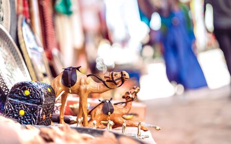 Small wooden dromedary camel at street market in Morocco - Travel shopping concept with manufactured...