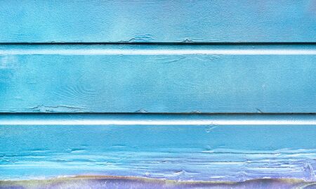 Blue painted background and alternative construction material - Wooden textured panel in outer fence...