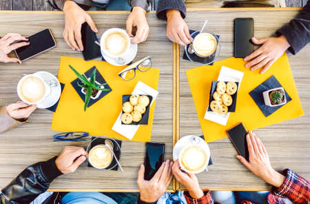 Top view of hands drinking at coffee shop restaurant - People having breakfast together with mobile...