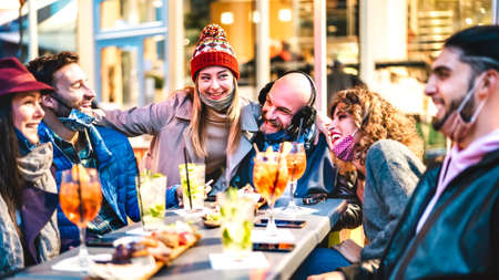 People joining cocktail happy hour at open air bar restaurant - New normal lifestyle concept with...