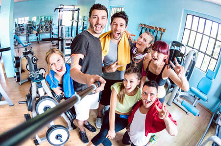 Happy young friends taking selfie after reopening of gym studio center - Sporty people ready for fitness training time together - Healthy life style and sport concept on bright azure filterの写真素材