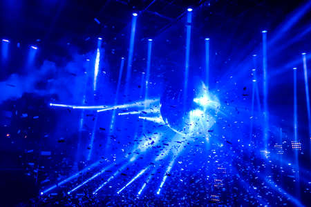 Laser show at generic party night club with bright spotlight on disco ball - Nightlife reopening concept about music and entertainment - Image with powered colored halos and vivid glowing lightsの写真素材