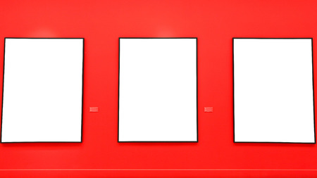Blank painting frames on red wallの写真素材