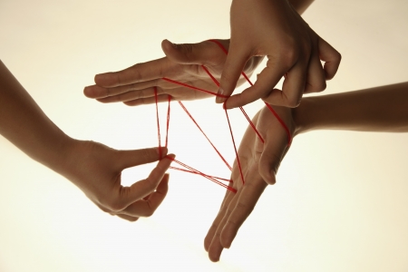 People playing cats cradle gameの写真素材