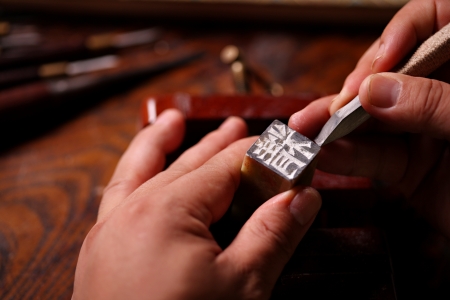 Chinese craftsman carving a stone sealのeditorial素材