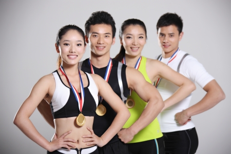 Group of young athletes holding trophyの写真素材