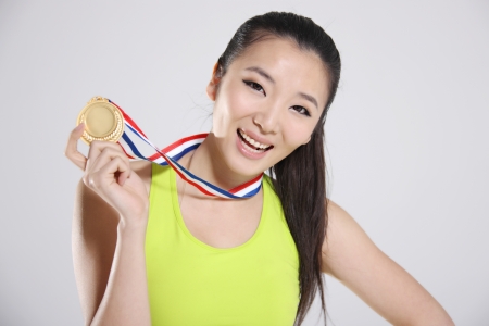young athlete holding medal,portraitの写真素材