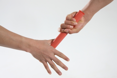Close-up of relay baton being passedの写真素材