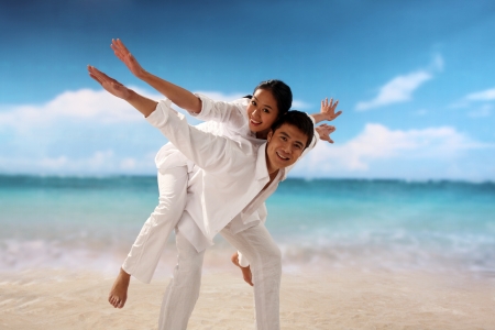 Playful couple at the beachの写真素材