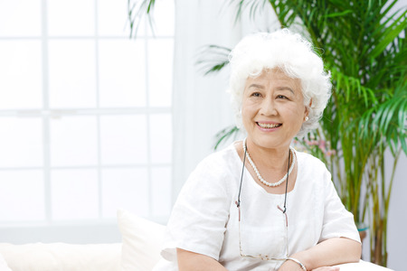 A shot of old woman at homeの写真素材