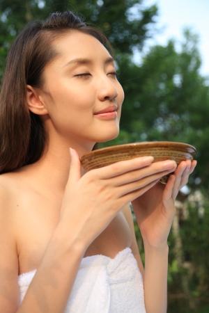 A shot of Yong woman holding a bowlの写真素材