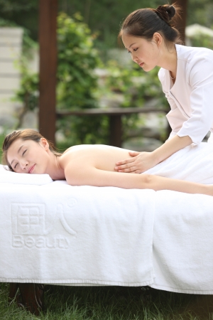 A shot of Young woman getting massage from masseuseの写真素材