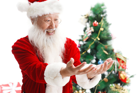 Happy Santa Claus looking at his handsの写真素材